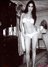 Černobílá fotografie Demi Moore v palvkách stojící uprostřed místnosti